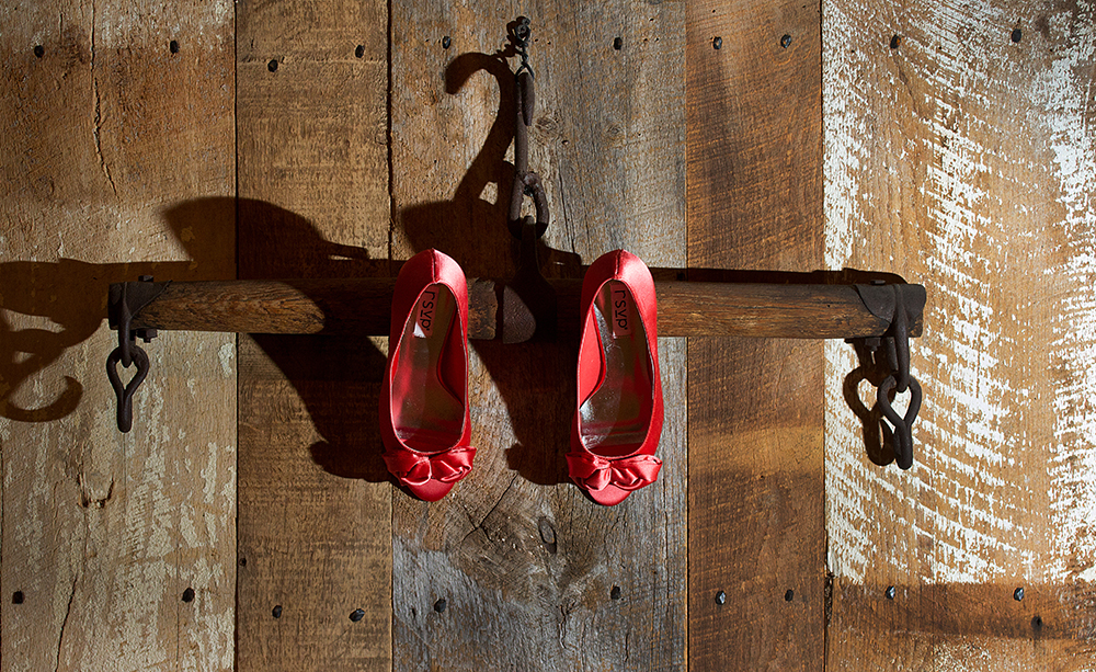 Pair of red shoes on hook.