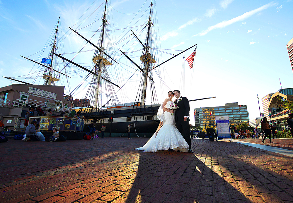 Newlyweds before majestic tall ship, capturing timeless moment