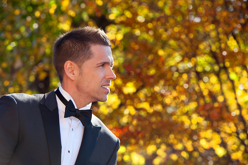 A well-dressed man in a tuxedo and bow tie.