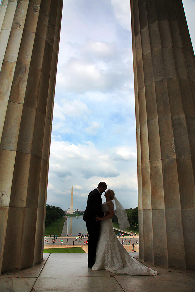 Newlyweds kiss at Lincoln Memorial, symbolizing love on their special day