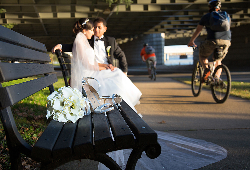 Bride and groom taking a break on a bench.