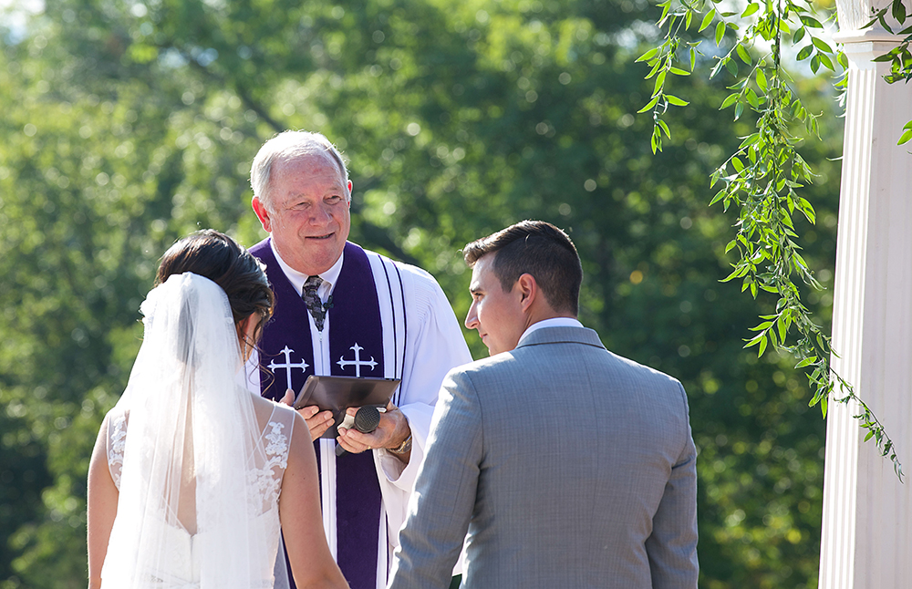Couple exchanging vows in a solemn ceremony.
