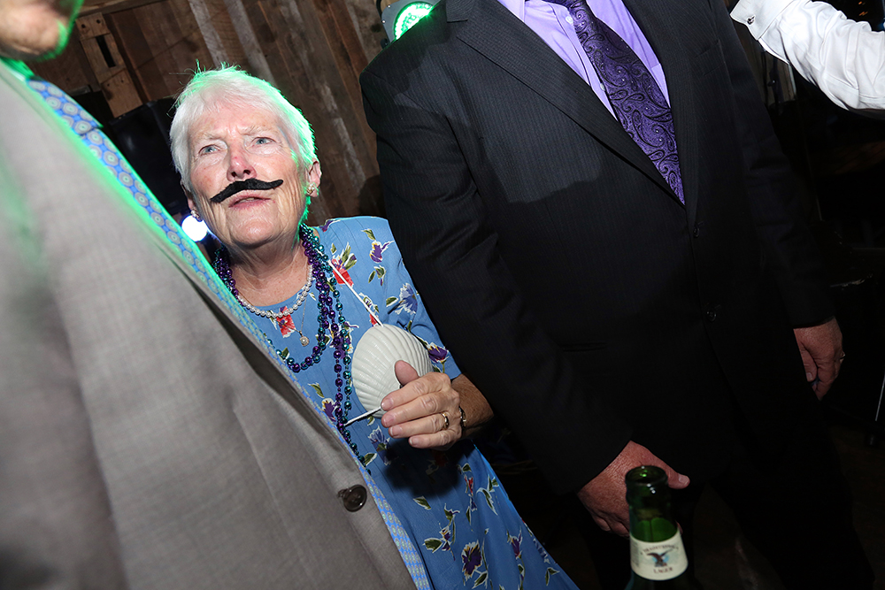 A man with a mustache and a woman holding a fan, exuding elegance and charm.