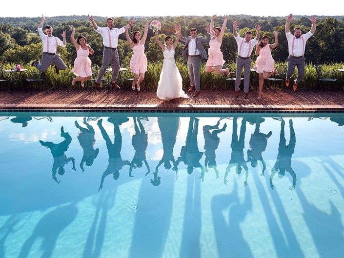 Newlyweds and guests celebrate with a splash in the pool.