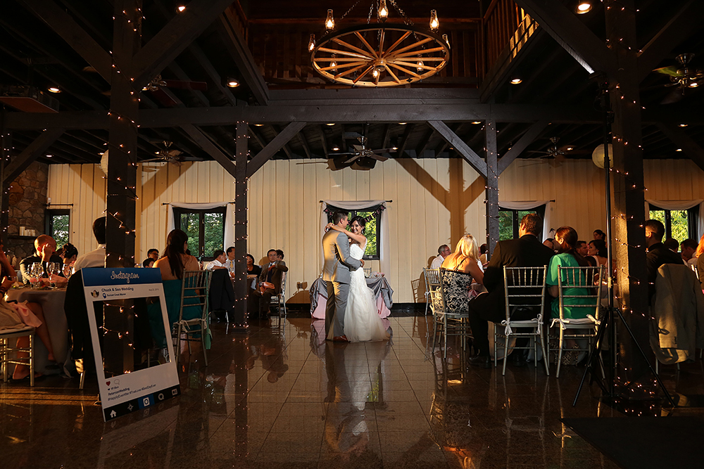 Newlyweds gracefully dancing at their joyous wedding reception.