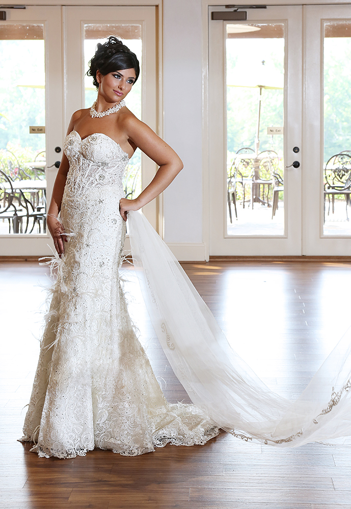 A woman in a wedding dress elegantly posing for a picture, radiating joy and anticipation on her special day.