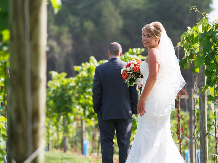 A happy couple walking amidst the picturesque vineyard.