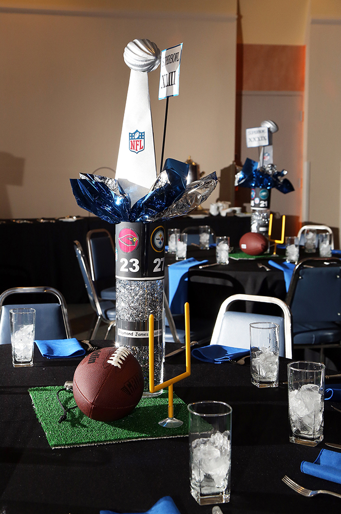 Sports equipment and bubbly arranged on a table.
