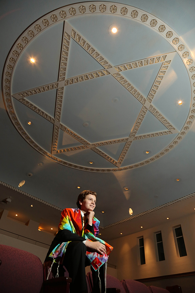 A woman sitting in a room with a star-shaped ceiling, exuding a serene ambiance, evoking a sense of wonder and tranquility.