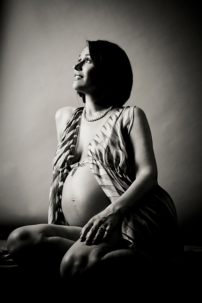 A pregnant woman in a black and white photo
