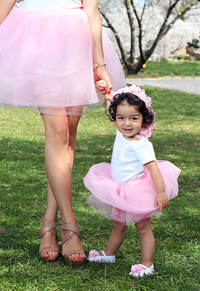 Mother and baby girl in pink tutus, radiating elegance and joy