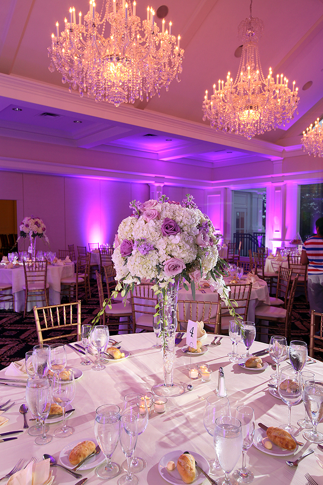Wedding reception set up in a spacious room with tables and chairs.