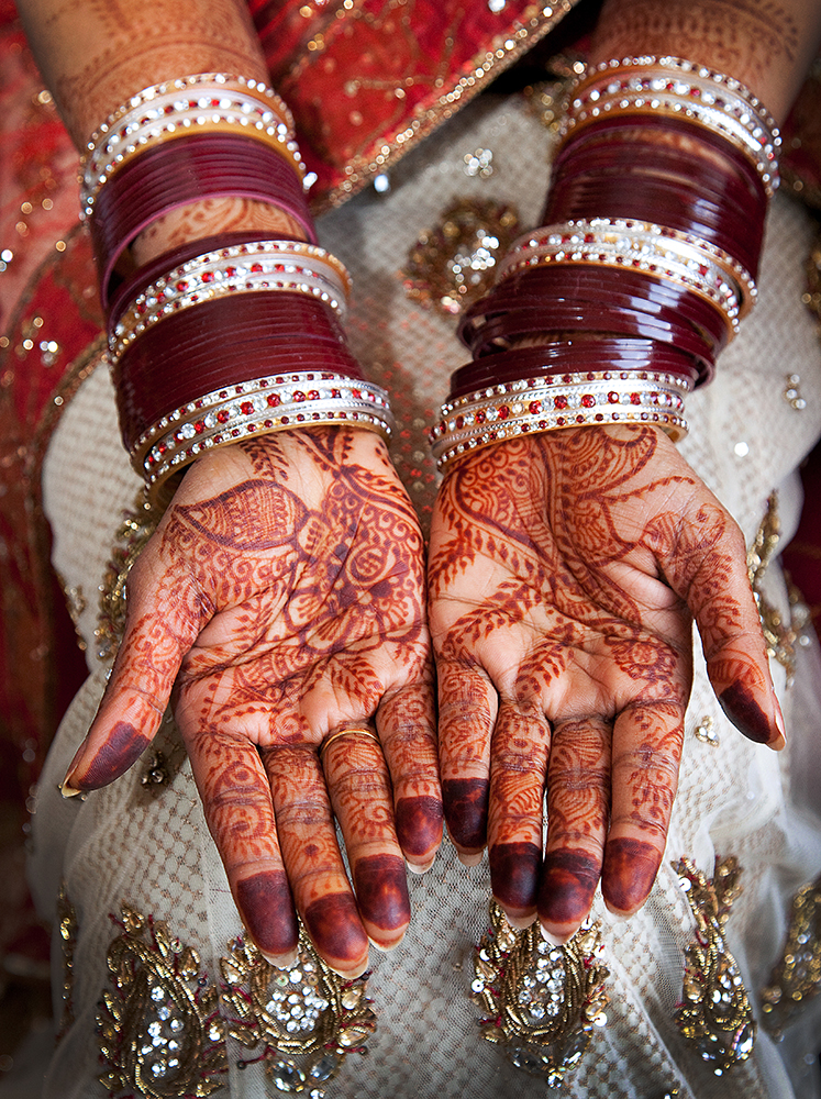 Henna-adorned hands of a woman.