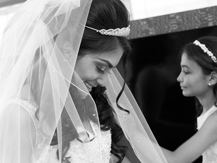Bride and daughter share a loving gaze on wedding day.