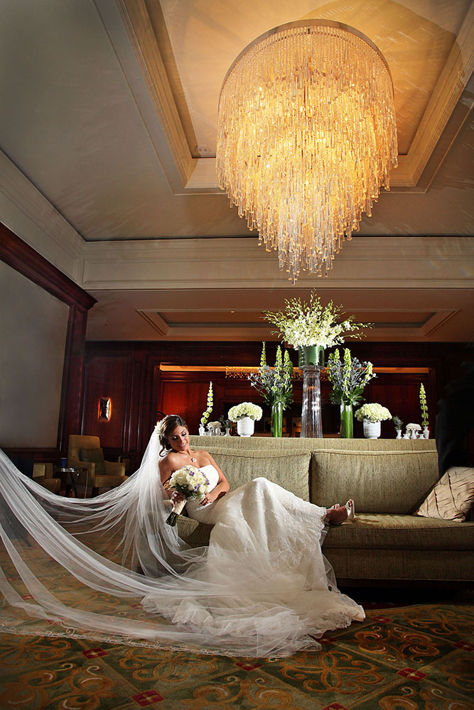 Bride posing on hotel couch.