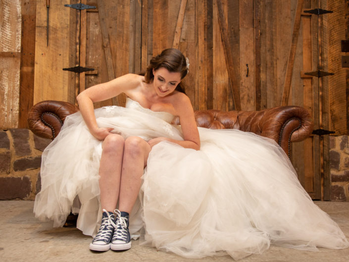 A Bride sitting on a couch, looking relaxed and comfortable.