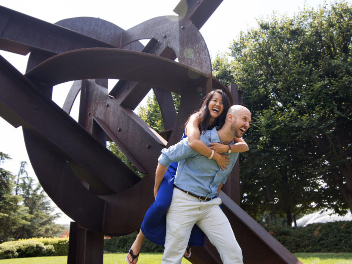 Two people hugging in a green outdoor space.