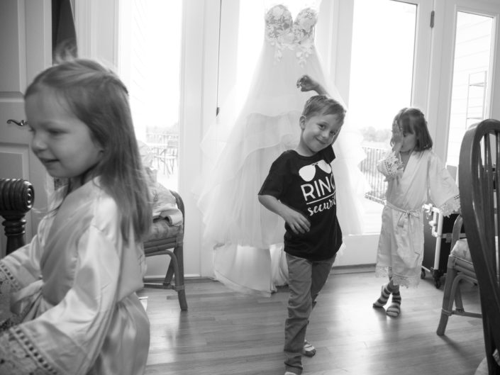 Kids joyfully playing with wedding dress, creating cherished memories.