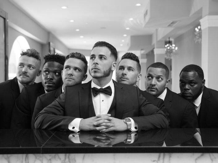 A group of men in tuxedos posing for a photo.
