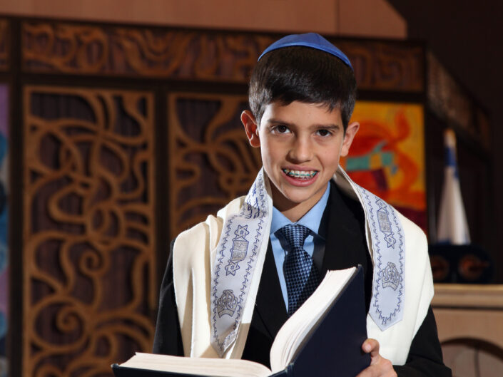 Boy holding a Bible and smiling in church